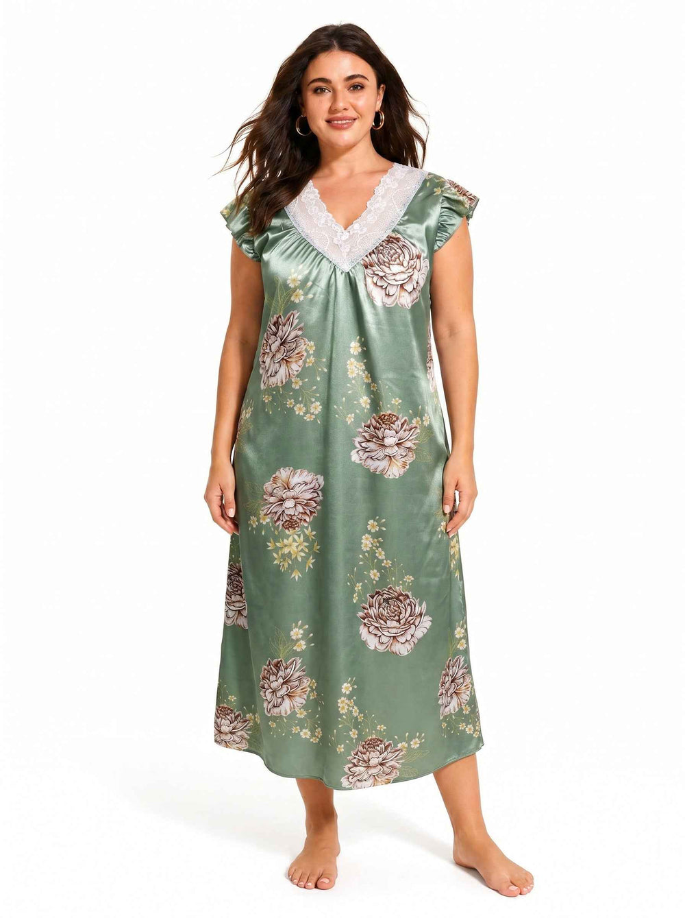 Woman standing and posing in a green floral satin nightgown