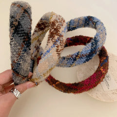 Four padded headbands with plaid patterns in various color combinations, arranged in a circular fashion.