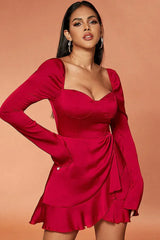 Model wearing a red satin mini dress with long bell sleeves and a ruffled hem.