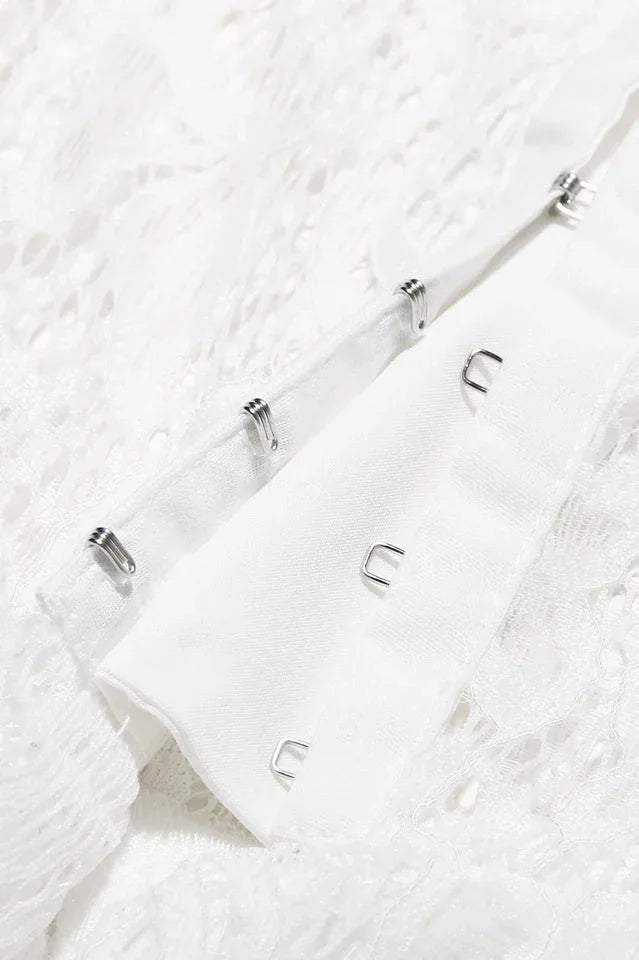 Detail of hook and eye closure on a white fabric.