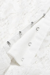 Detail of hook and eye closure on a white fabric.