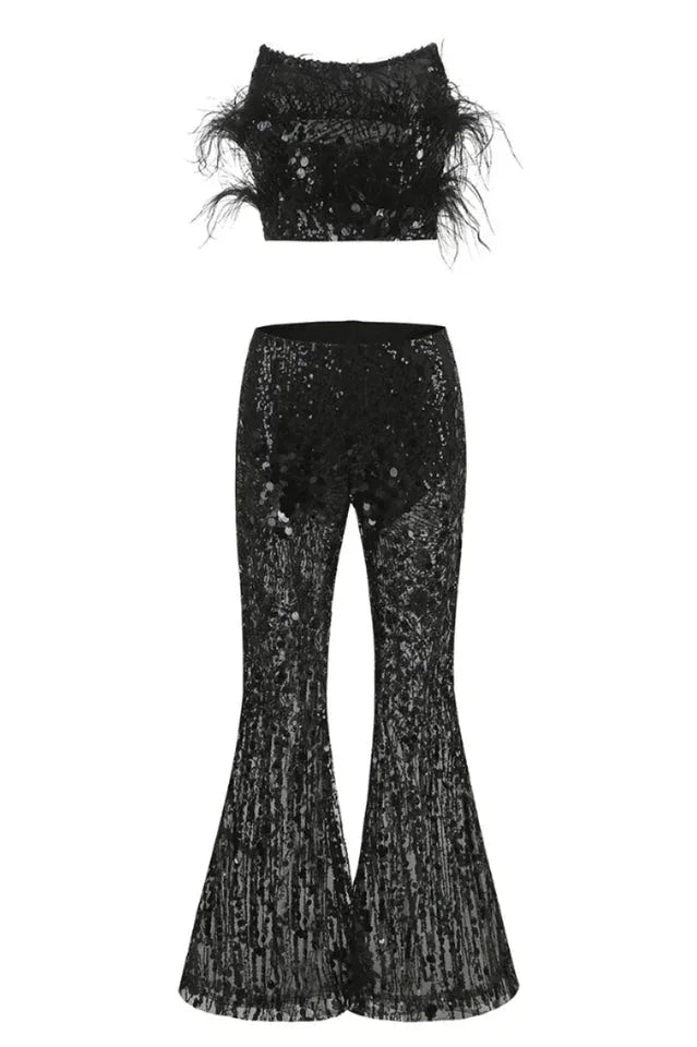 Black sequined cropped bandeau top with feather trim and matching flared sequined pants, laid flat.
