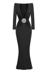 Black floor-length dress with a deep V-neck, long sleeves, and a jeweled embellishment at the waist.