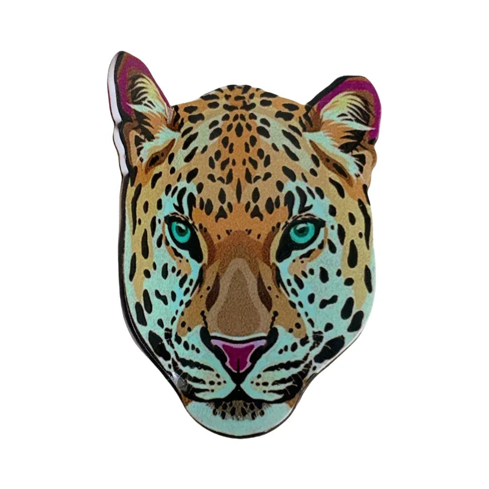 Close-up of a leopard head accessory with vibrant blue eyes and spotted fur