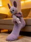 Close-up of a light purple ankle sock with a plush bat character attached to the cuff, worn on a person's foot.