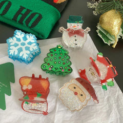 Various glittery Christmas hair claw clips including Santa, snowman, Christmas tree, and snowflake