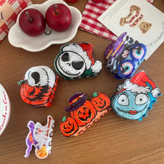 A variety of Halloween-themed hair clips including pumpkins, Jack Skellington, Sally, a ghost, and a creature with eyeballs.