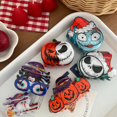 A top-down view of Halloween-themed hair clips on a white plate, surrounded by decorative elements.