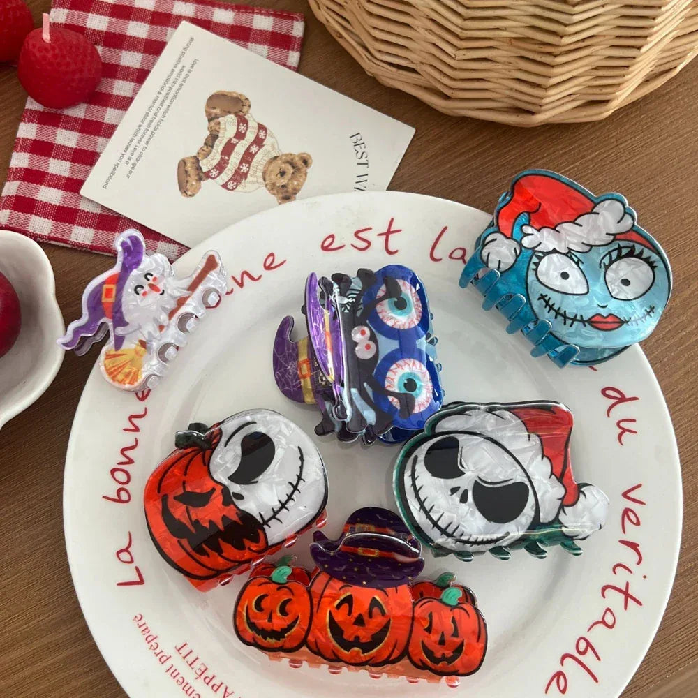 A collection of Halloween-themed hair clips arranged on a plate and a wooden surface.