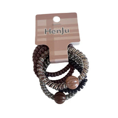 A close-up shot of a pack of spiral hair ties with brown beads.