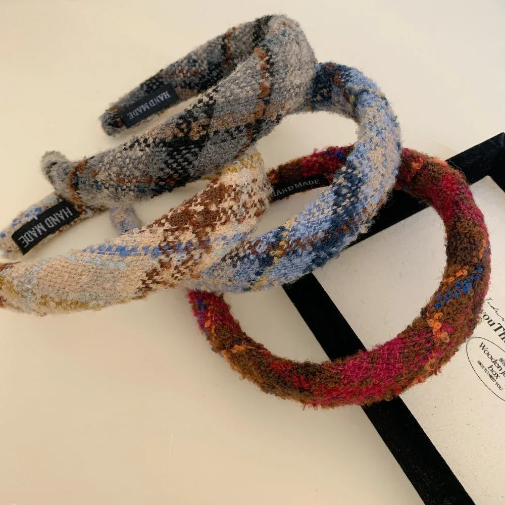 A group of three padded headbands with plaid patterns, showcasing different colorways.