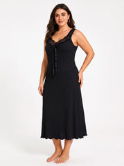 Full-body shot of a woman in a black ribbed knit nightgown