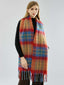 Woman wearing a multi-colored plaid scarf with fringed edges