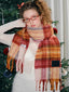 Model wearing a plaid scarf and white top