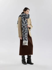 Full body shot of a woman in a tan blazer, brown skirt, and leopard print scarf