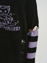 Detail of the striped sleeves and cut-out on the sweater