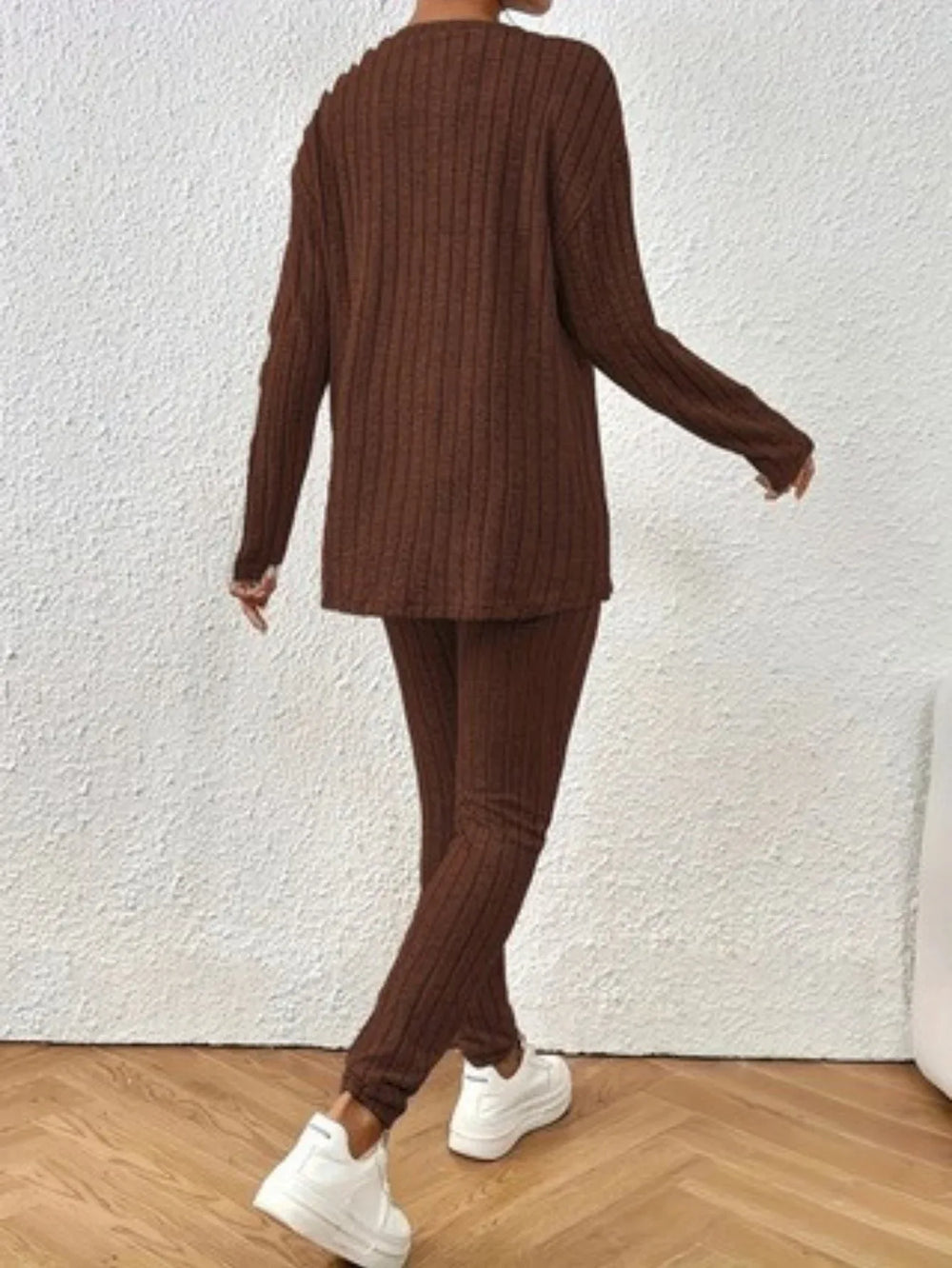 Back view of a woman wearing a brown ribbed knit loungewear set.