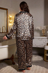Back view of a woman wearing a leopard print satin pajama set.