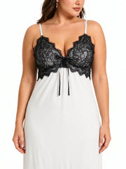 Front view of a woman wearing a white satin slip dress with a black lace bust and adjustable straps