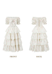 Front view of a white floral print off-the-shoulder tiered dress with puffed sleeves and a bow detail