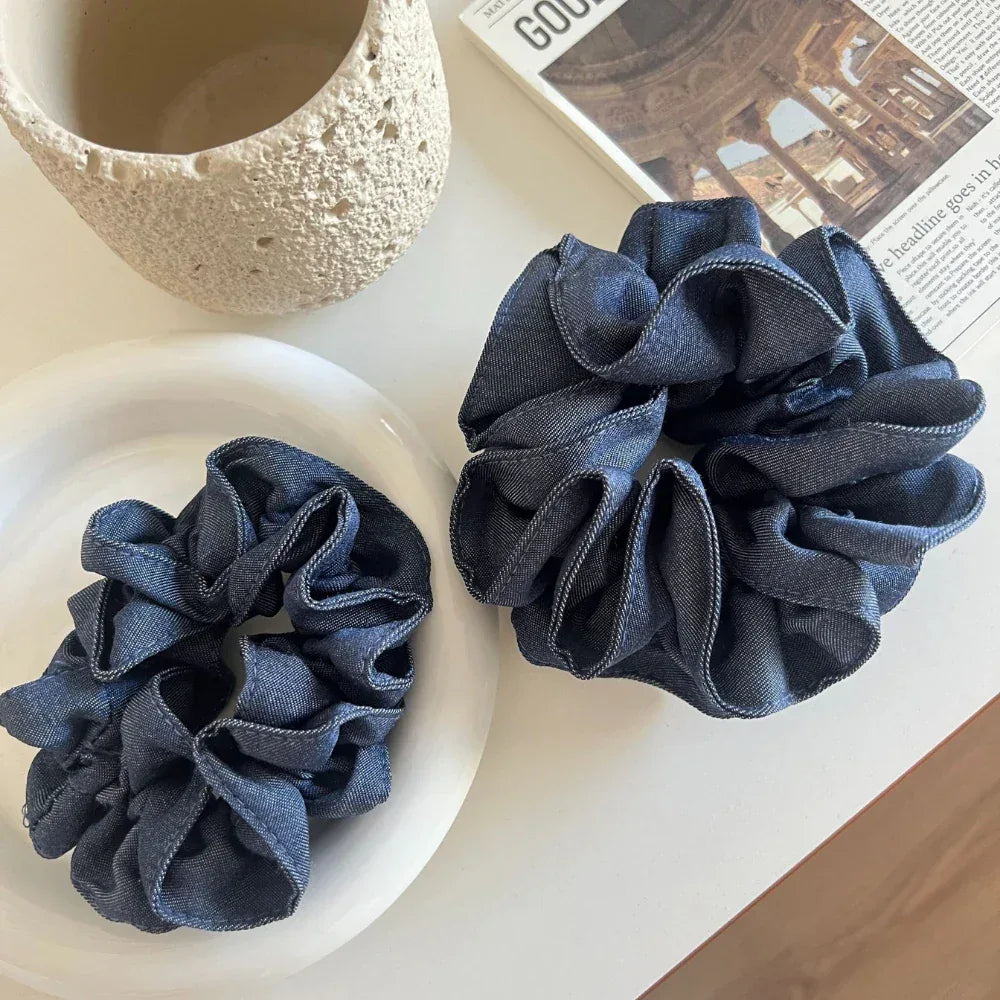 Two denim scrunchies on a white plate