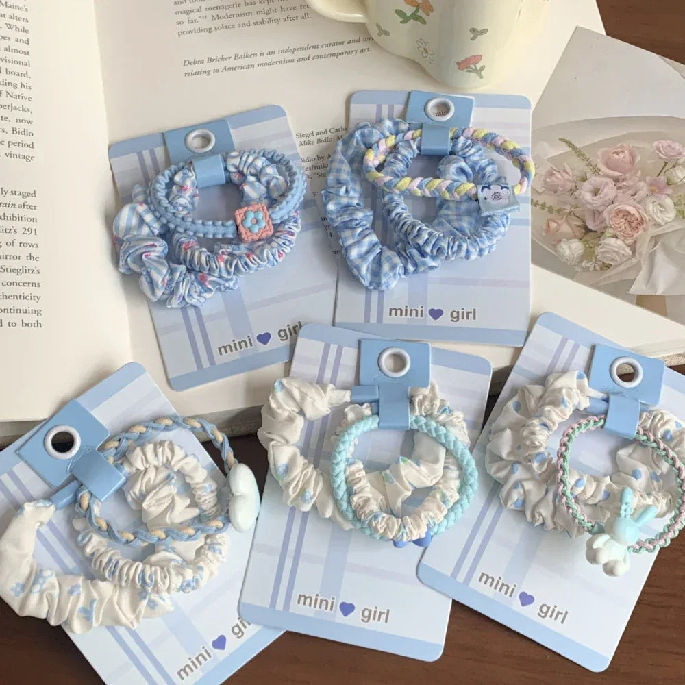 Close-up of scrunchie sets with intricate patterns and small charms