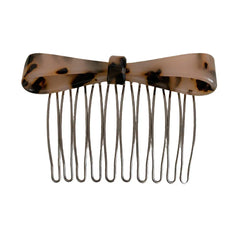 A tortoiseshell bow comb is shown against a white background.