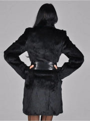 Back view of a woman in a black faux fur coat cinched with a black leather belt