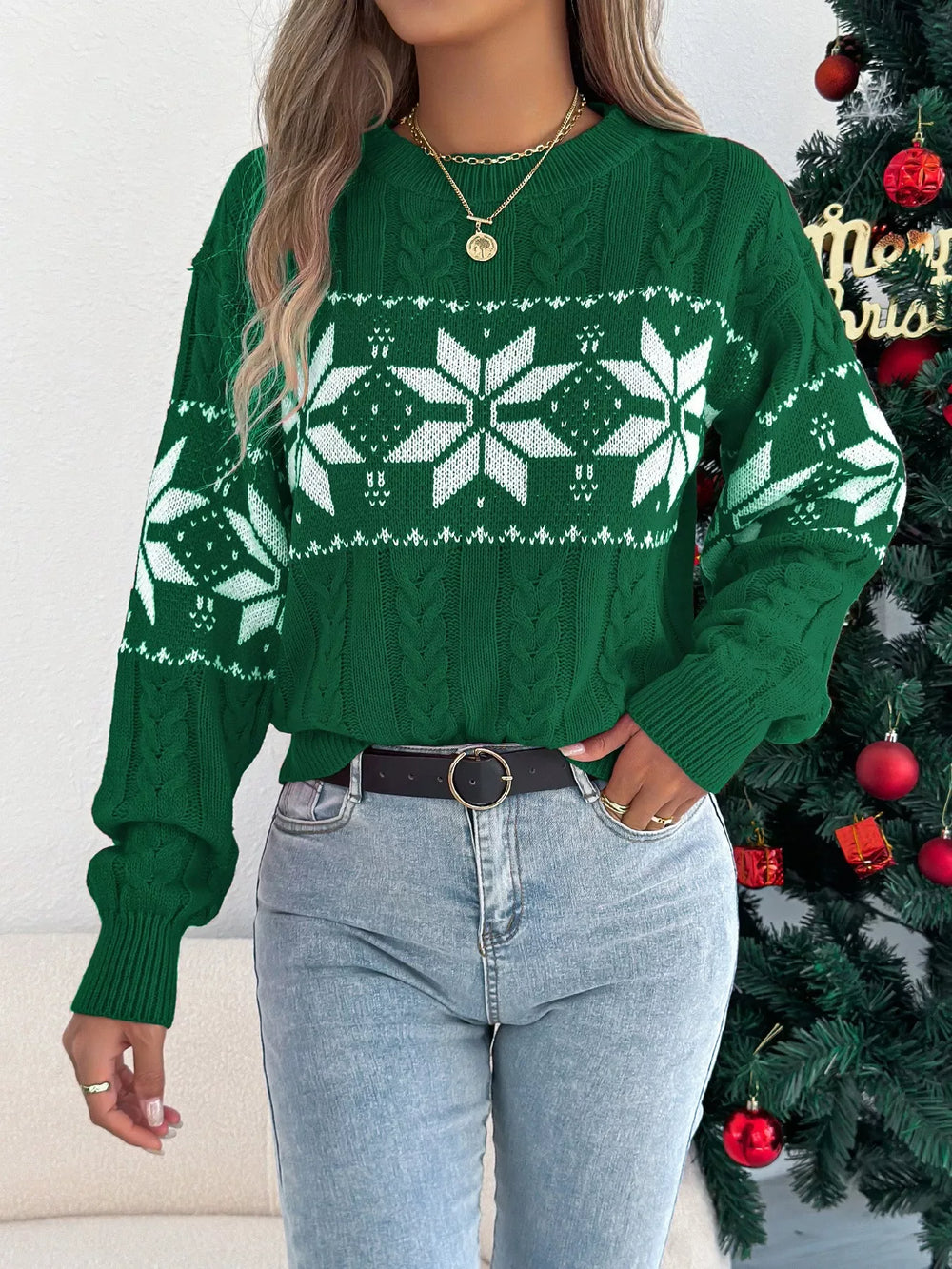 woman wearing green snowflake print knit sweater with jeans and belt