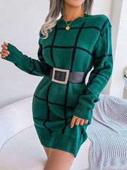 Woman wearing a green and black plaid knit sweater dress with a black belt