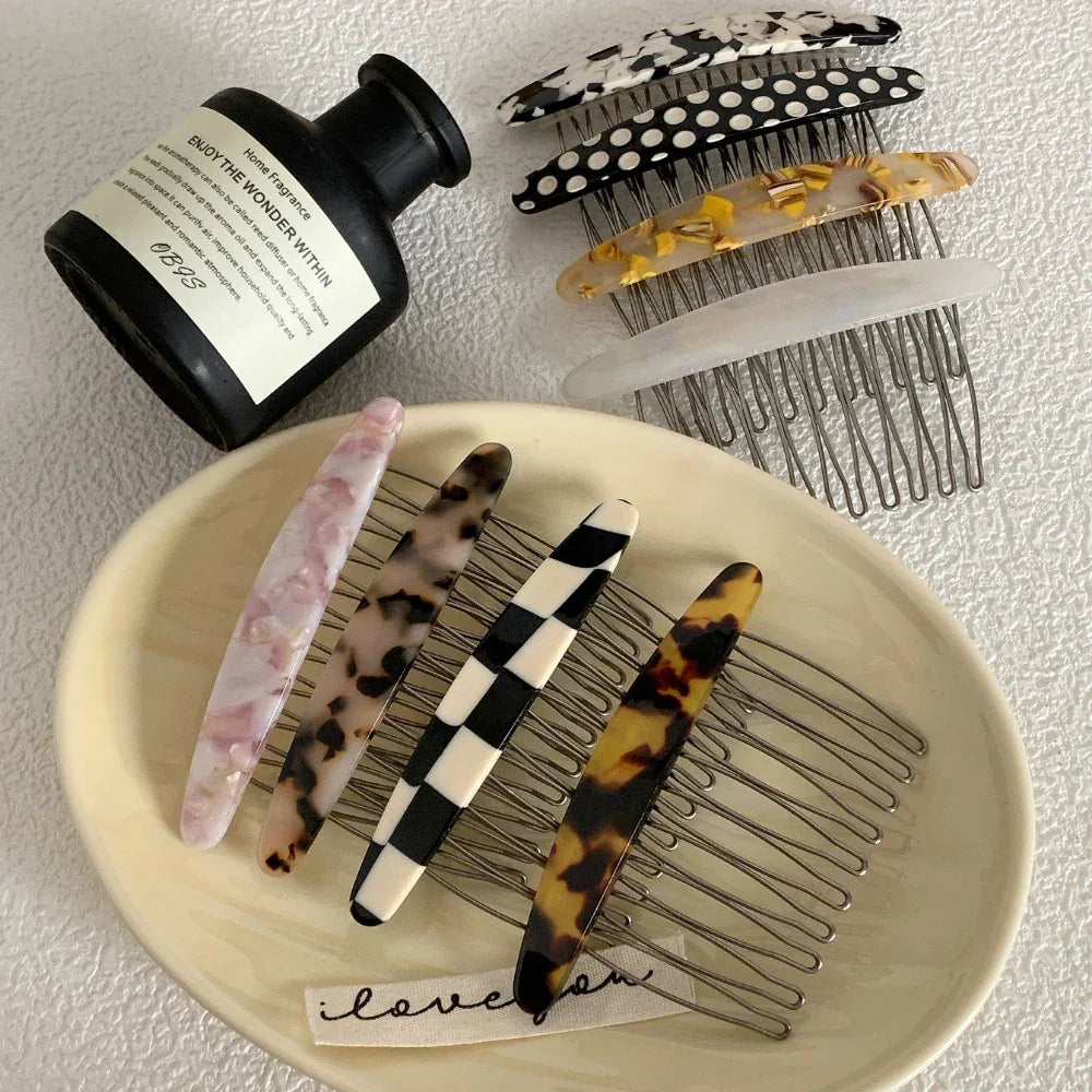Selection of patterned hair combs with a fragrance bottle