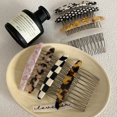 Selection of patterned hair combs with a fragrance bottle