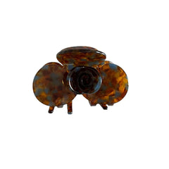 A single brown and blue floral-shaped acetate hair claw clip.