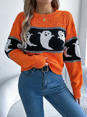 Close-up of a woman wearing an orange Halloween sweater with a ghost print, showing the texture and fit.