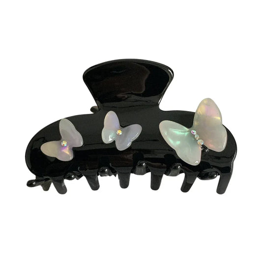 Black claw clip with iridescent butterfly embellishments and gem accents