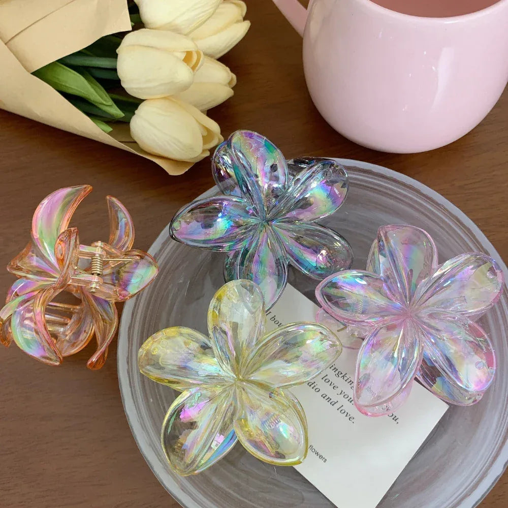 close-up of iridescent flower claw hair clips on a plate