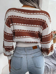 Back view of a woman wearing a brown and white striped cropped knit sweater and light wash jeans.