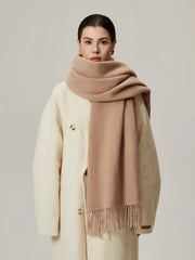 Woman wearing a cream coat and a solid beige scarf