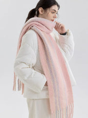 Woman wearing a pink and purple striped scarf with fringe detail over a white puffer jacket, side view