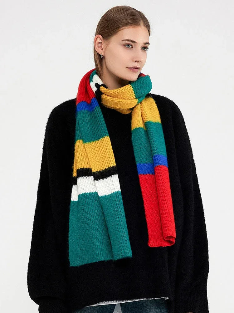 Woman wearing a black sweater and a multicolored striped knit scarf