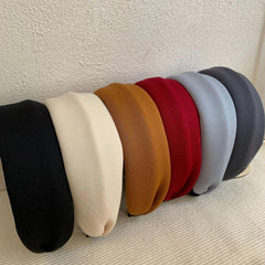 Collection of padded headbands in various colors: black, cream, brown, red, light blue, dark grey