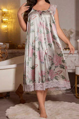 Woman wearing a satin nightgown with a floral and butterfly print, featuring lace trim on the sleeves and hem.