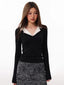 Model wearing a black long-sleeved top with a white contrast collar and a leopard print skirt.