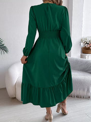 back view of a woman wearing a long green dress