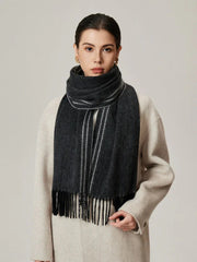 Close-up of a woman wearing a charcoal gray scarf with white stripes