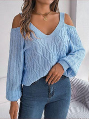 woman wearing a light blue cold shoulder cable knit sweater with blue jeans