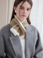 Close-up of a woman wearing a striped knit scarf