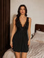 Front view of a woman wearing a black V-neck lace trim nightdress with a bow detail.