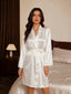 Front view of a woman wearing a white satin bridal robe with a tie waist