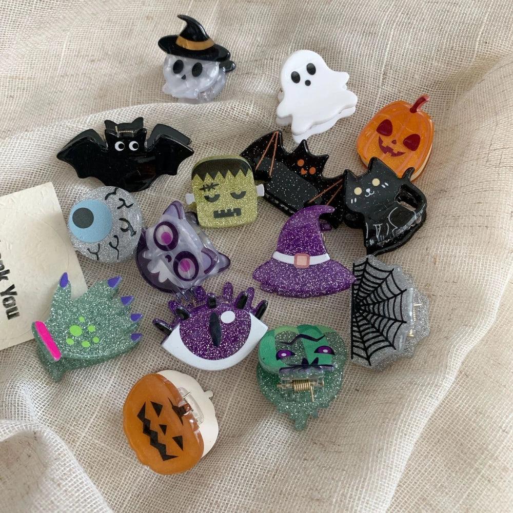 Assorted Halloween hair accessories featuring glitter and character designs